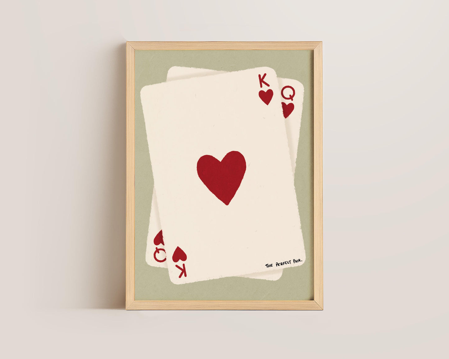Bedroom wall featuring Queen of Hearts poster framed against neutral wall