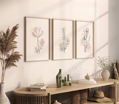 Three-piece wall art set with delicate floral line drawings