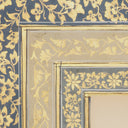 Close up of vintage Islamic wall art with gold-toned accents