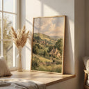 Sunlit fields and distant hills across a pastoral landscape