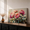 Framed canvas artwork of pink peonies with soft petals